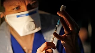 Doctor Claire Chatt prepares the Pfizer-BioNTech vaccine inside Salisbury Cathedral in Salisbury, England
