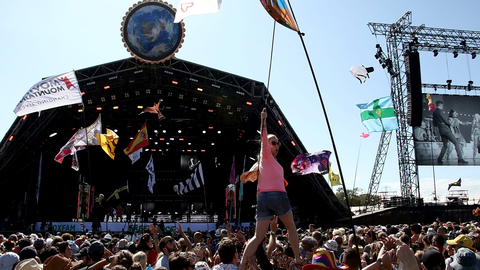 In this Sunday, June 30, 2019 file photo, revellers react to Kylie Minogue as she performs at the Glastonbury Festival, Somerset, England.