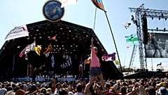 In this Sunday, June 30, 2019 file photo, revellers react to Kylie Minogue as she performs at the Glastonbury Festival, Somerset, England.