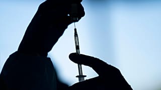 A medical staff member prepares the Pfizer-BioNTech COVID-19 vaccine on Thursday, Jan. 21, 2021.