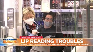 People wearing masks in a shop