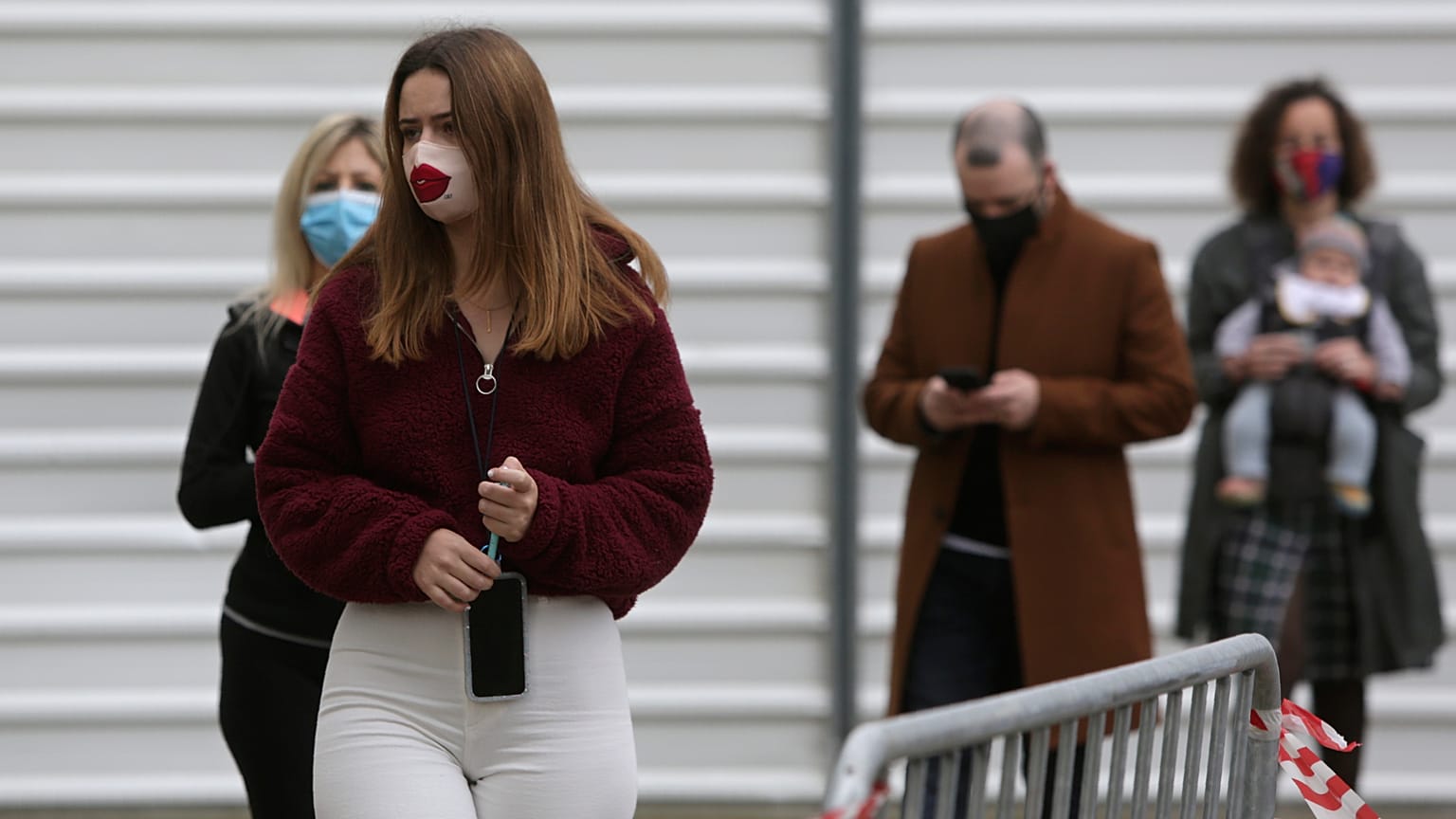 People queue to vote outside a polling station in Lisbon, Sunday, Jan. 24, 2021.