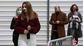 People queue to vote outside a polling station in Lisbon, Sunday, Jan. 24, 2021.