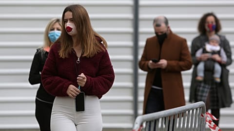 People queue to vote outside a polling station in Lisbon, Sunday, Jan. 24, 2021.