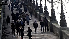 People exercise along the bank of the River Thames in London, Saturday, Jan. 23, 2021 during England's third national lockdown.