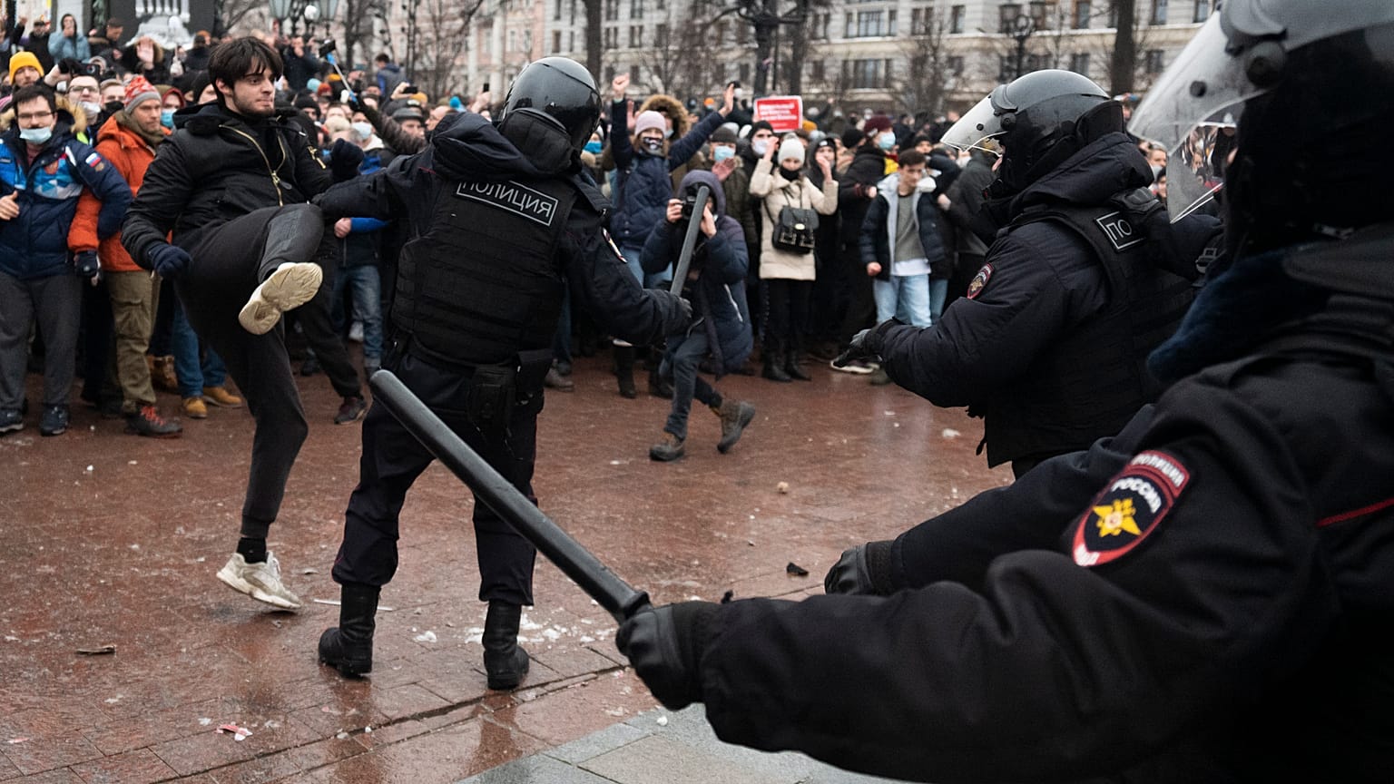 A demonstrator clashes with a police officer during a protest against the jailing of opposition leader Alexei Navalny in Moscow, Russia, Jan. 23, 2021