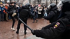 A demonstrator clashes with a police officer during a protest against the jailing of opposition leader Alexei Navalny in Moscow, Russia, Jan. 23, 2021