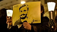 Amnesty International activists hold a picture of Giulio Regeni at a demonstration in Rome on January 25, 2017.