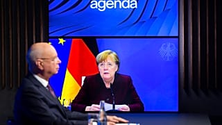 German Klaus Schwab, left, Founder and Executive Chairman of the World Economic Forum, WEF, listens to German Chancellor Angela Merkel