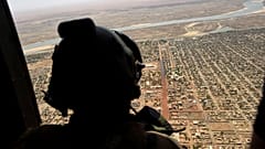 A French soldier stands inside a military helicopter on operation in Mali.