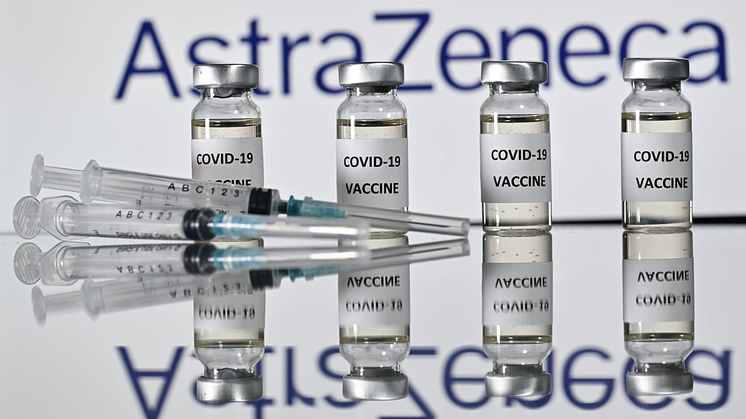 An illustration picture shows vials with Covid-19 Vaccine stickers attached and syringes with the logo of British pharmaceutical company AstraZeneca on November 17, 2020. 