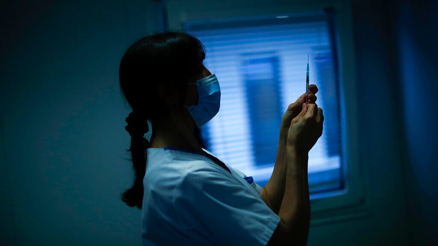 A nurse prepares a syringe with Pfizer/Biontech COVID-19 vaccine as medical workers are vaccinated at the MontLegia CHC hospital in Liege, Belgium