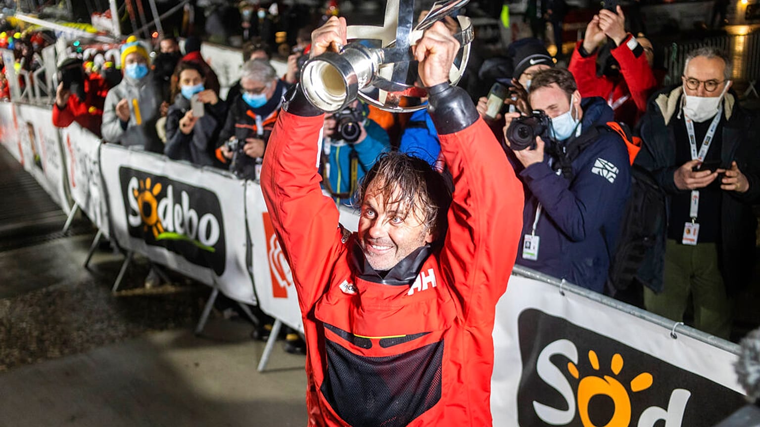 Skipper Yannick Bestaven mit dem Siegerpokal im Zielhafen Les Sables d` Olonne