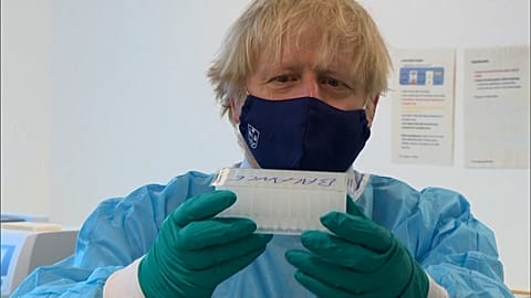 UK Prime Minister Boris Johnson with COVID-19 swab samples at Queen Elizabeth University Hospital in Glasgow.