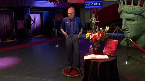 Wide of Larry King wax figure in model.