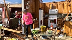 Patti Herring sobs as she sorts through the remains of her home after it was destroyed by a tornado. Fultondale, Alabama, USA. January 26, 2021
