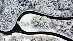 Cars on the Col du Mollendruz mountain pass after snowfall in the Jura Mountains, Mont-la-Ville, Switzerland