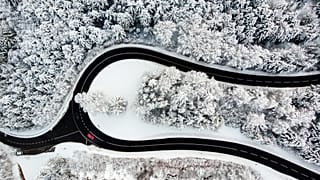 Cars on the Col du Mollendruz mountain pass after snowfall in the Jura Mountains, Mont-la-Ville, Switzerland