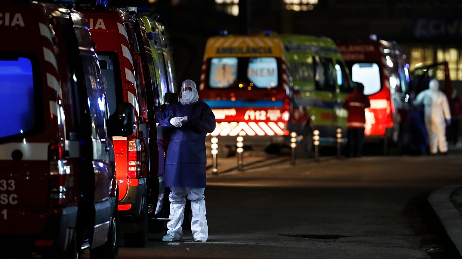 More than thirty ambulances queue waiting to hand over their COVID-19 patients to medics at the Santa Maria hospital in Lisbon, Thursday, Jan. 28, 2021. 