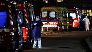 More than thirty ambulances queue waiting to hand over their COVID-19 patients to medics at the Santa Maria hospital in Lisbon, Thursday, Jan. 28, 2021. 