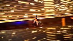 A cyclist, wearing a face mask to prevent the spread of the coronavirus COVID-19, rides a bicycle past the EU headquarters in Brussels