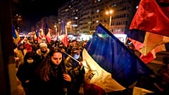 Protesters waving flags march after a deadly fire at a hospital treating COVID-19 patients in Bucharest, Romania, Saturday, Jan. 30, 2021. 