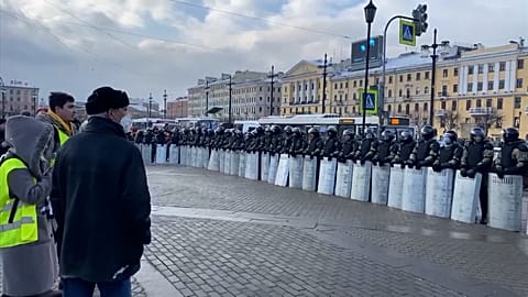 Long row of police officers with riot shields