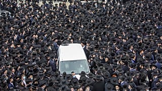 Thousands of ultra-Orthodox Jews participate in the funeral for prominent rabbi Meshulam Soloveitchik, in Jerusalem, Sunday, Jan. 31, 2021. 