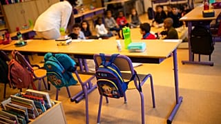 A teacher, wearing a face mask to fight against the spread of the coronavirus during school at the Heembeek primary school in Brussels, Tuesday, Sept. 1, 2020.