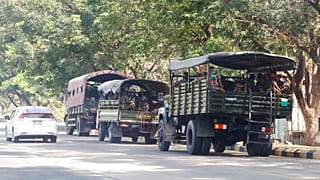 Soldiers sit inside trucks parked on a road in Naypyitaw, Myanmar, Monday, Feb. 1, 2021.