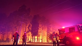 Firefighters attend a fire at Wooroloo, near Perth, Australia, Monday, Feb. 1, 2021.
