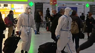 People wear Hazmat suits at airport
