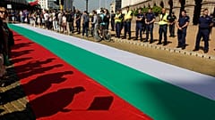 Protestors' shadows are cast on a giant Bulgarian flag amid demonstrations in Sofia demanding the government's resignation