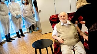 Resident Carl-Einar Joergensen receives a second dose of the Pfizer BioNTech vaccine from Dr Puk Laugen at Plejecenter Faelledgaarden, in Copenhagen, Denmark, Jan. 23. 2021. 