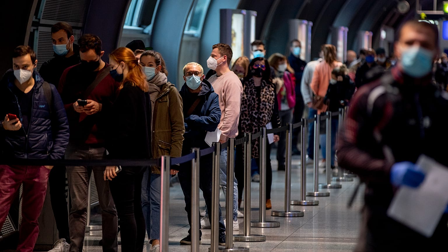 People queue at a Covid-19 test center at the airport in Frankfurt, Germany