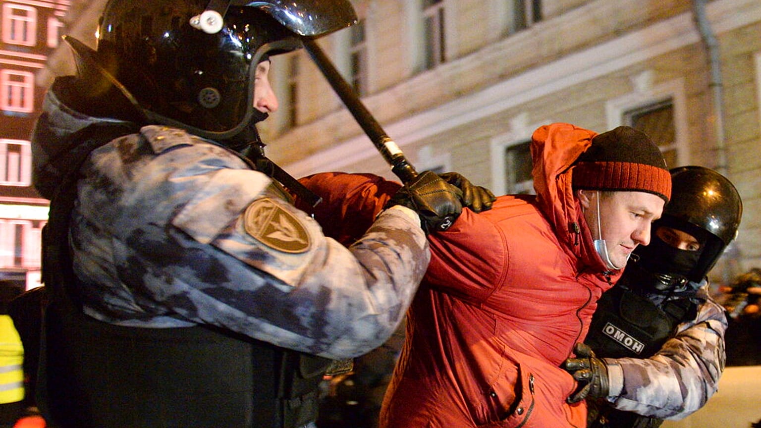 Police officers detain a Navalny supporter at the Red Square in Moscow, Russia, Tuesday, Feb. 2, 2021