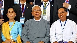 In this May 24, 2017, file photo, Myanmar's Vice President Myint Swe (R) sits with State Counsellor Aung San Suu Kyi (L) and then-President Htin Kyaw in Myanmar.