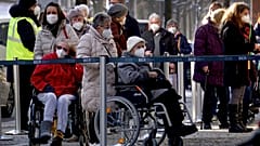 People queue in front of the vaccination center against the COVID -19 disease at the 'Arena Treptow' in Berlin, Germany, Monday, Feb. 1, 2021. 