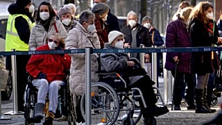 People queue in front of the vaccination center against the COVID -19 disease at the 'Arena Treptow' in Berlin, Germany, Monday, Feb. 1, 2021. 