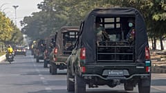 A convoy of army vehicles patrol the streets in Mandalay, Myanmar, Wednesday, Feb. 3, 2021.