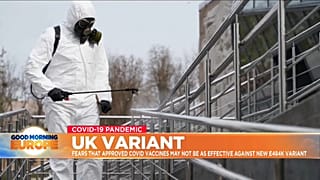 Man in hazmat suit cleans handrail in UK