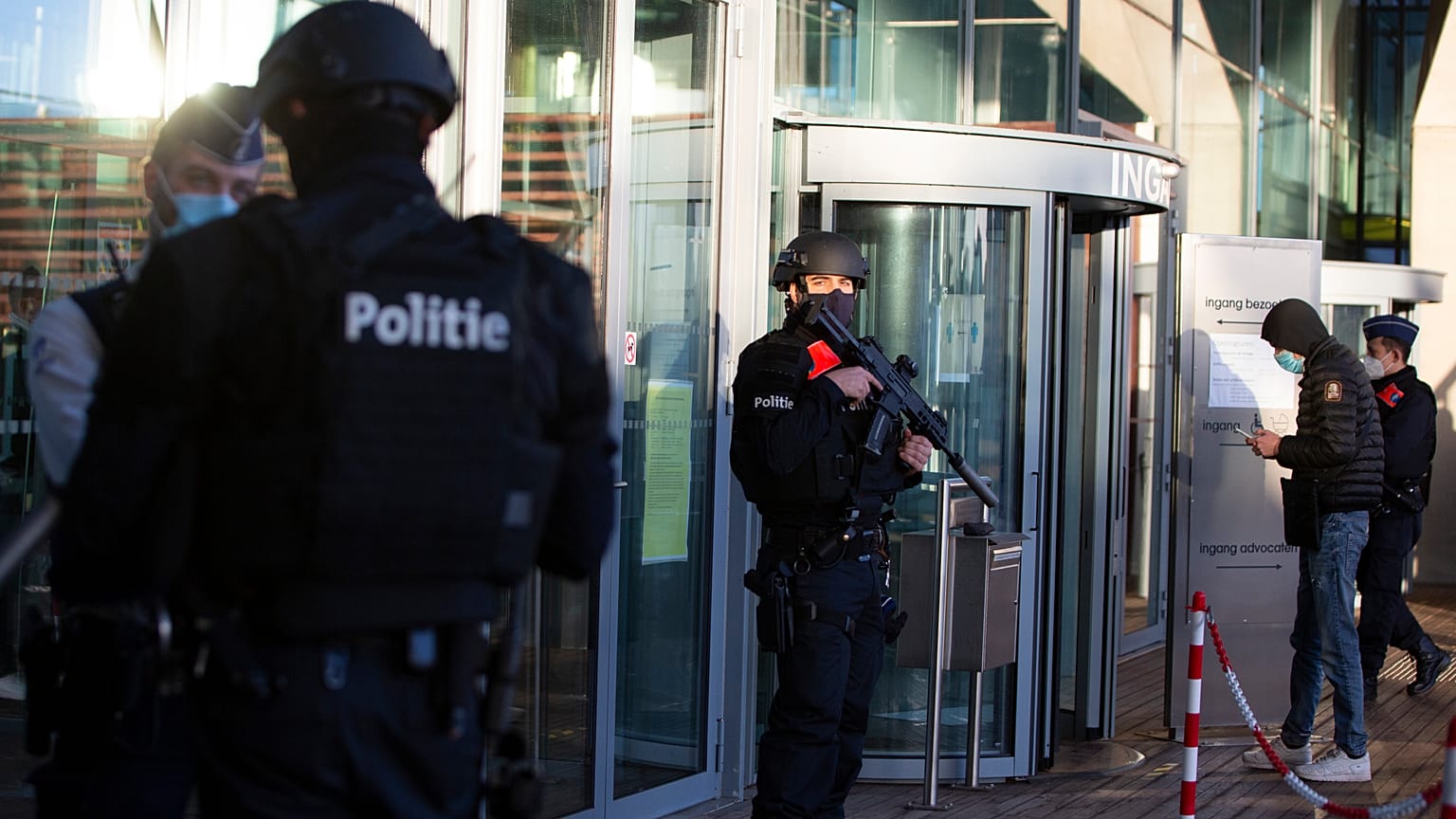Police patrol outside the courthouse in Antwerp.