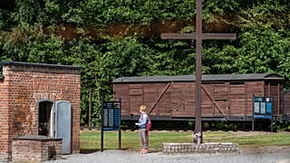 A woman is seen next to a gas chamber at the museum of the former Nazi Death Camp Stutthof, in Sztutowo, July 21, 2020. 