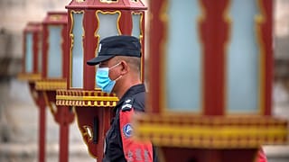 ضابط أمن يرتدي كمامة أمام معبد السماء في بكين، الصين.
