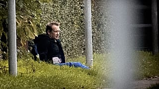 Images from the escape showed Peter Madsen sitting on the grass against a fence with his hands behind his back as police aimed guns at him from a distance.