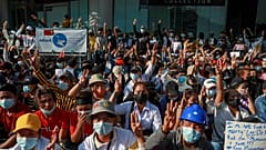 Demonstrator flash three-fingered salutes, a symbol of resistance, during a protest in Yangon, Myanmar, Wednesday, Feb. 10, 2021.