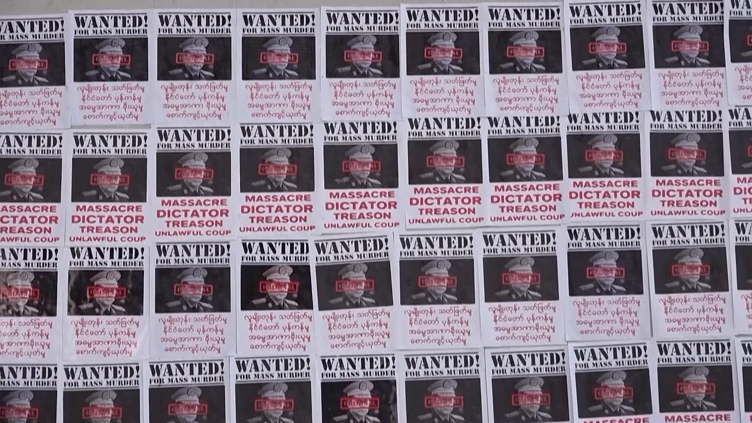 Photos of commander in chief Min Aung Hlaing with "wanted for mass murder" written on it