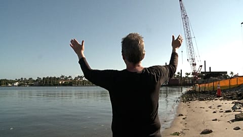 Woman singing with her arms open