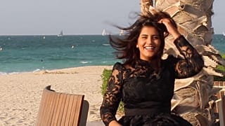 This undated handout picture released on the Facebook page of Saudi activist Loujain al-Hathloul shows her posing for a picture in a dress by a beach.