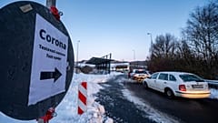 Cars queue in front of a Corona test station at the German-Czech Republic border in Furth im Wald, Germany, Monday, Jan. 25, 2021. 